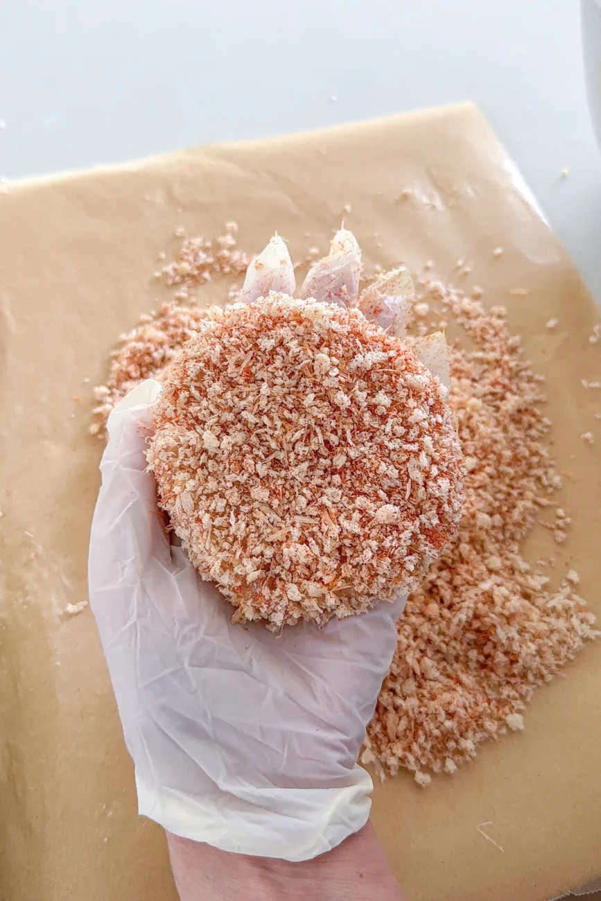 Raw chicken burger patty coated in parmesan panko crumbs
